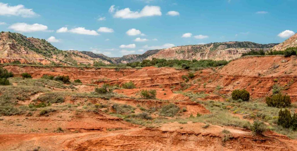 See the  impressive cliffs and red rock formations of Palo Duro Canyon State Park at the end of Canyon Sweep, one of the scenic drives in Texas.
