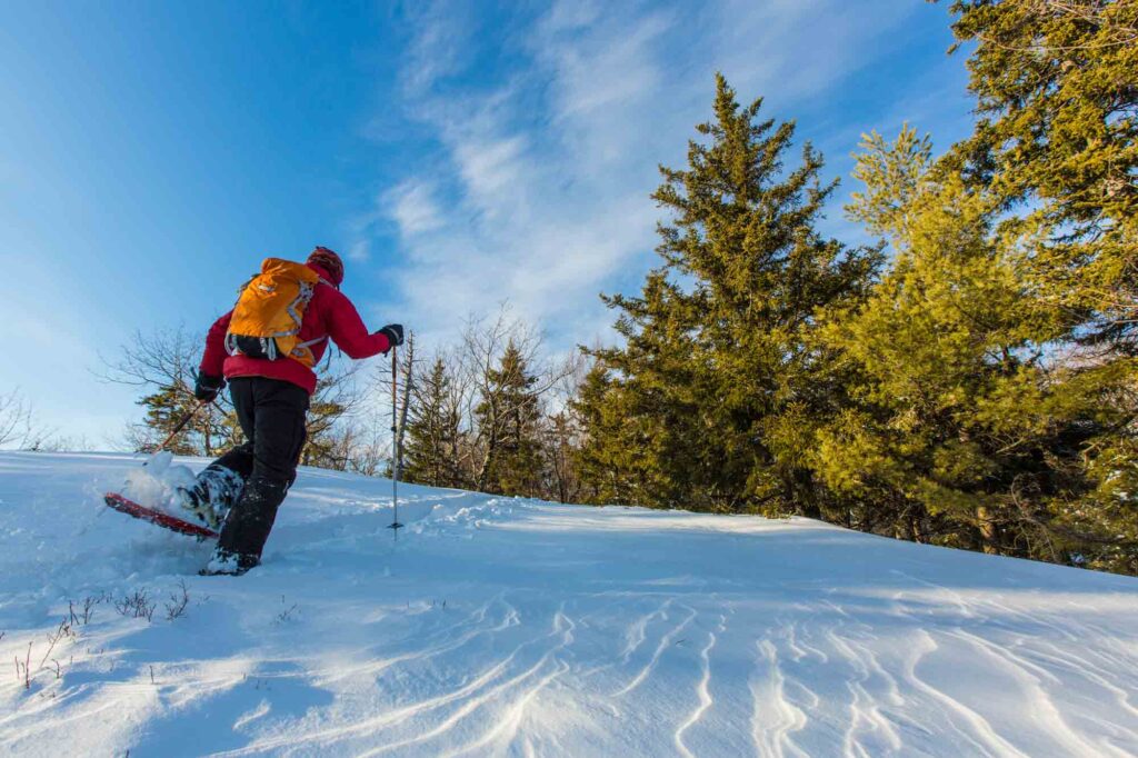 Exploring New Hampshire's winter wonderland by snowshoeing is one of the fun things to do in New Hampshire in winter