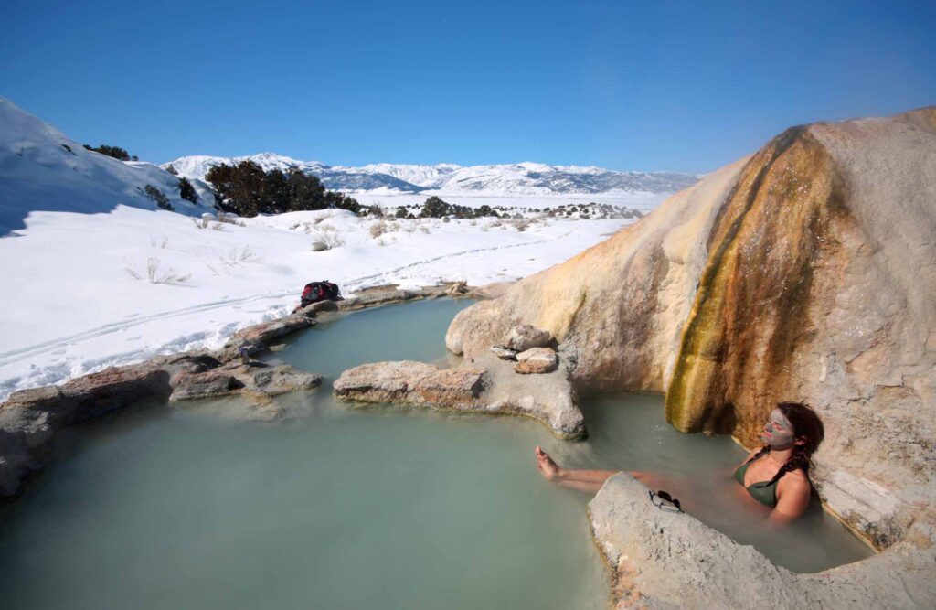 A woman soaks in natural hot springs in California