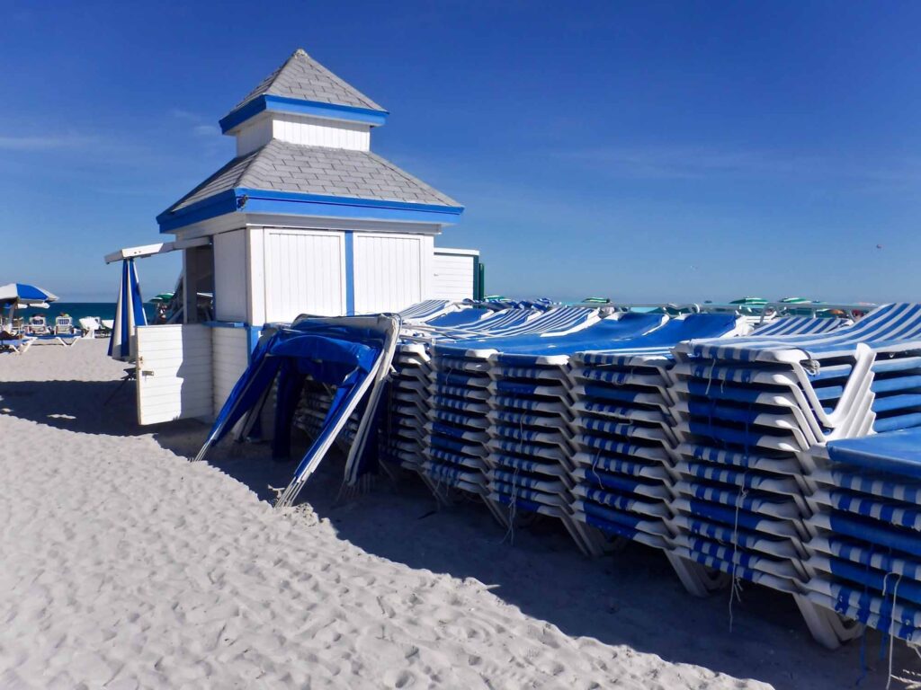A blue and white concession stand by the beach