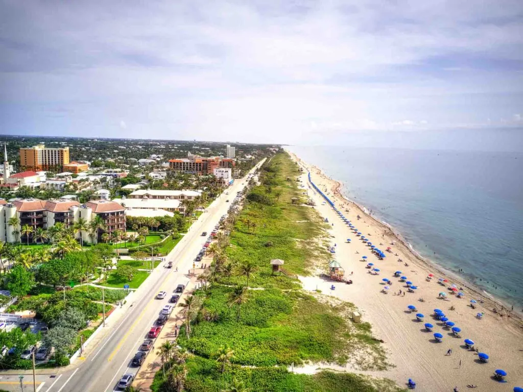 Aerial shot of Delray beach lined with beach umbrellas