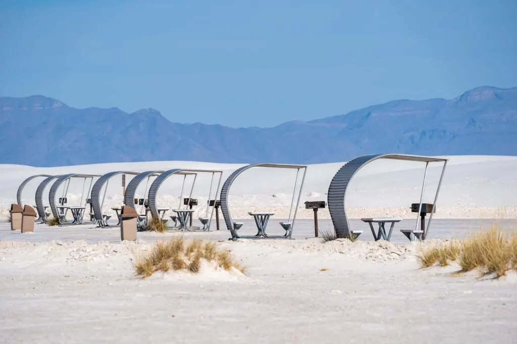 retro style picnic rest area tables and structures inside of White Sands National Park in New Mexico