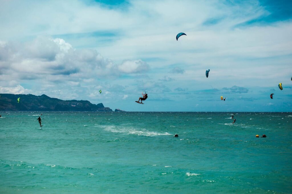 Kitesurfers riding the wind and the waves at Kanaha Beach Park in Maui, Hawaii