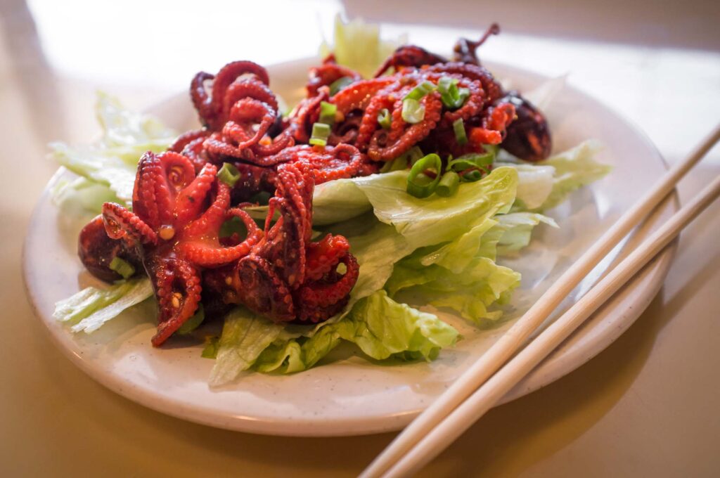 Enjoying a plate of grilled octopus is an great romantic date idea in Houston for foodies