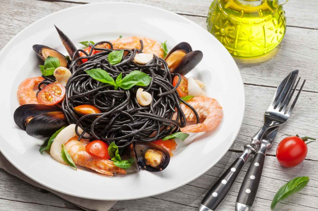 an inviting plate of black of spaghetti with shrimp
