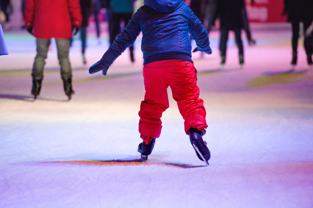 Child ice skating at night