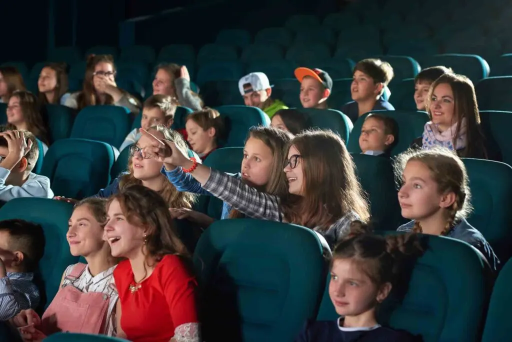 Children sitting in audience of movie or theater