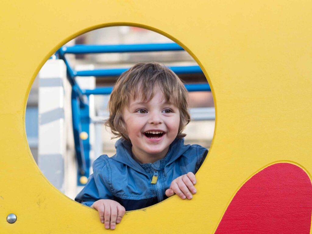 Funny cute happy baby playing on the playground